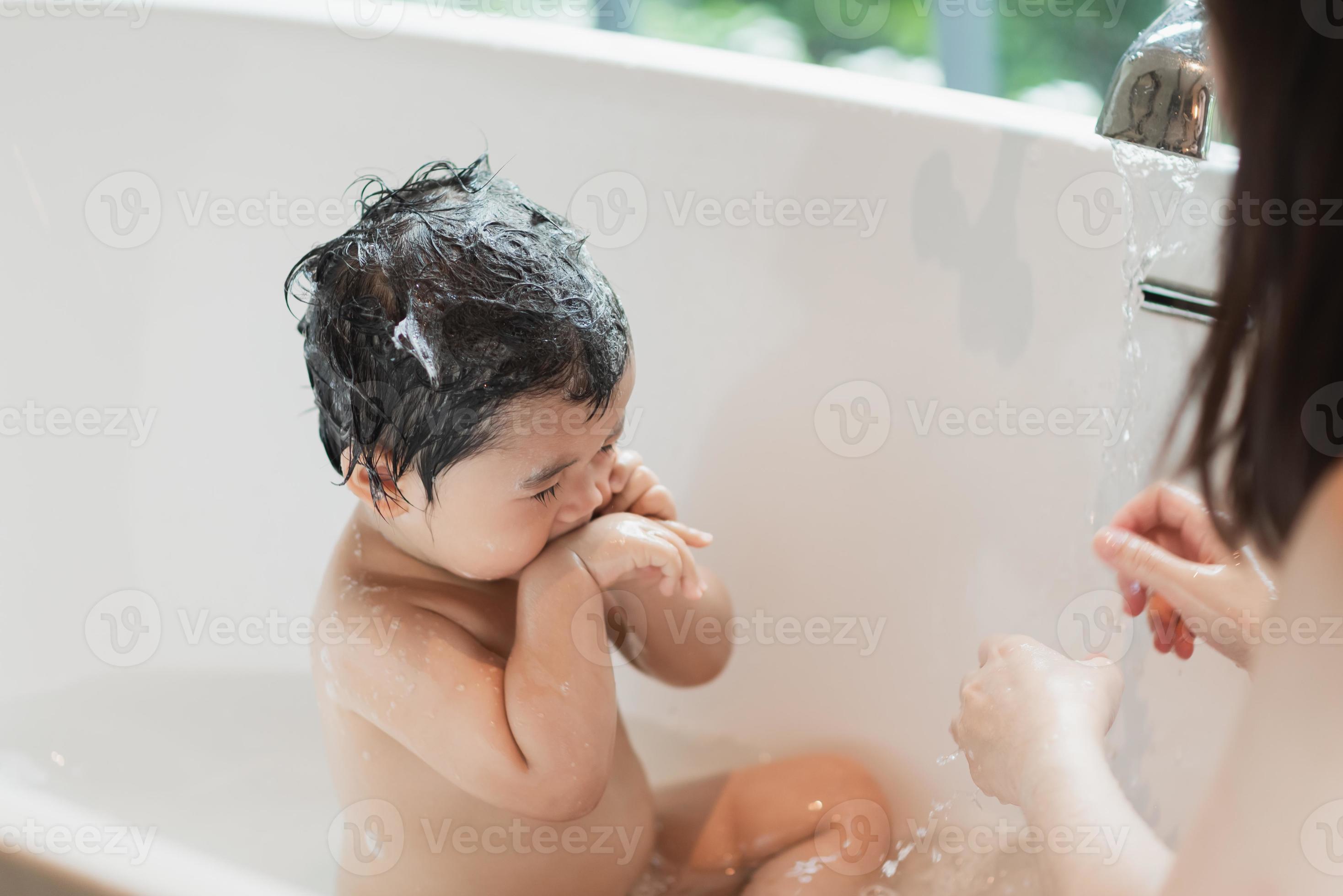 Asian cute kid girl toddler having a bath wash hair cleaning bathing