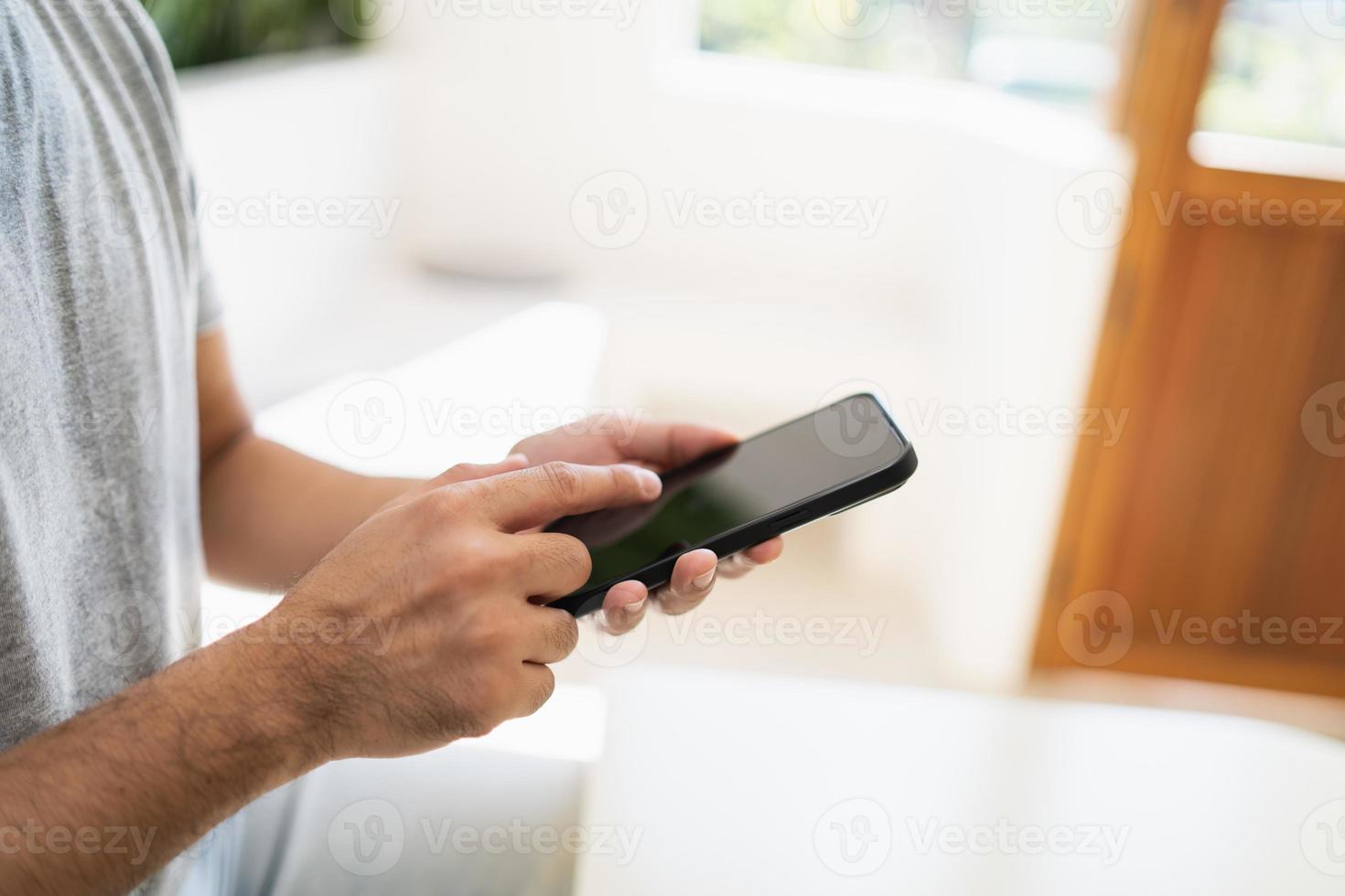 Close up man hold mobile phone text or message on white screen. Businessman use modern smartphone to browse web, read e-book, trade stocks, trade crypto currency. Business communication concept. photo