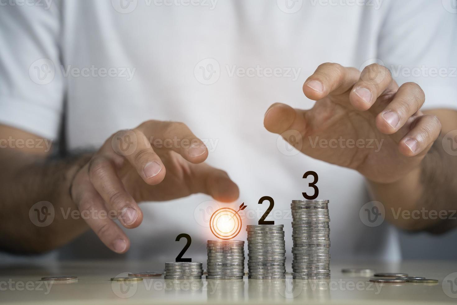 Hand business man place protect 2023 on top rows stack of coins with copy space. Saving money and financial tax payment banking plan for new year concept for investment future in new year 2023. photo