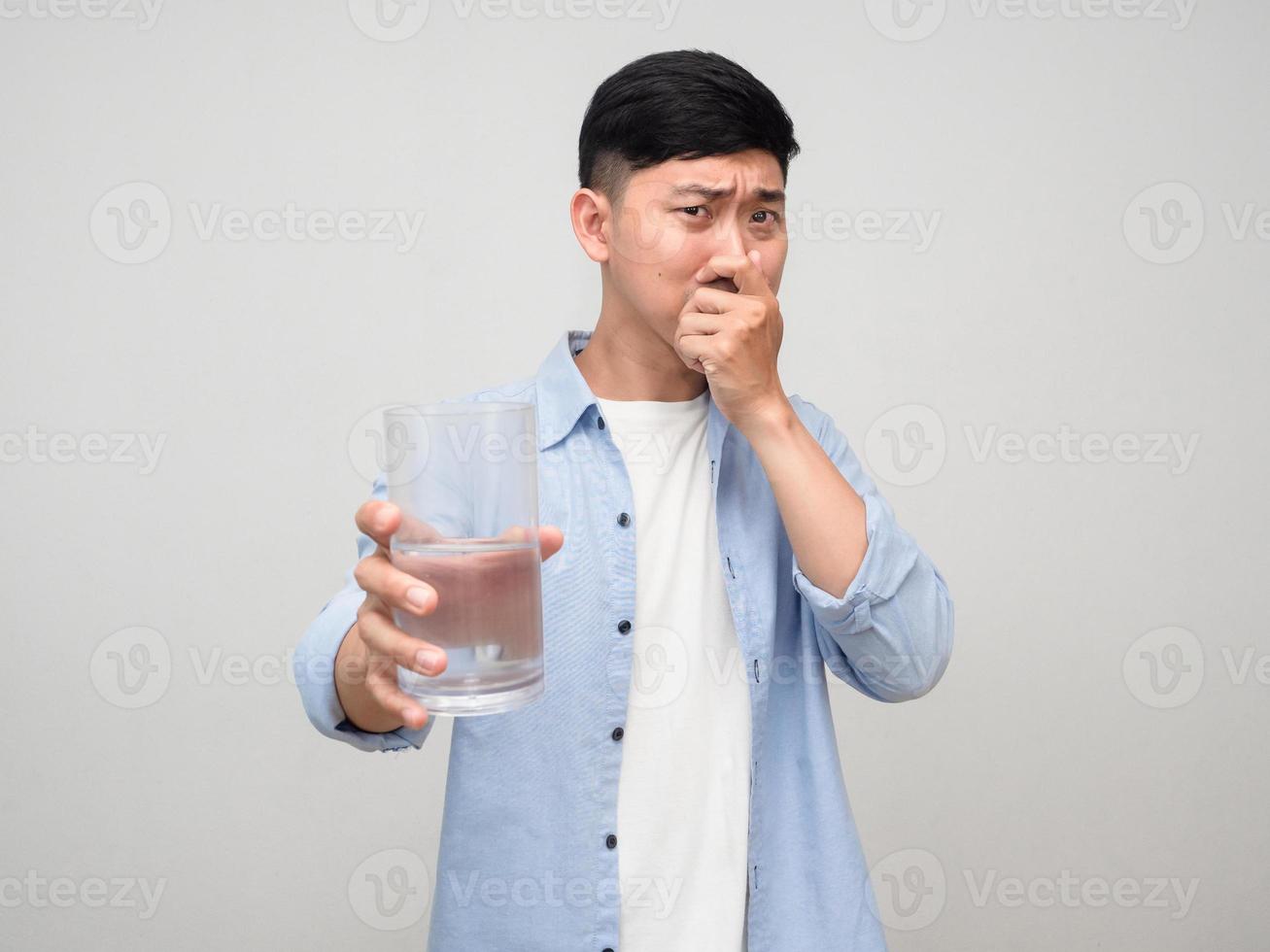 Man close his nose giving glass of water to you isolated photo
