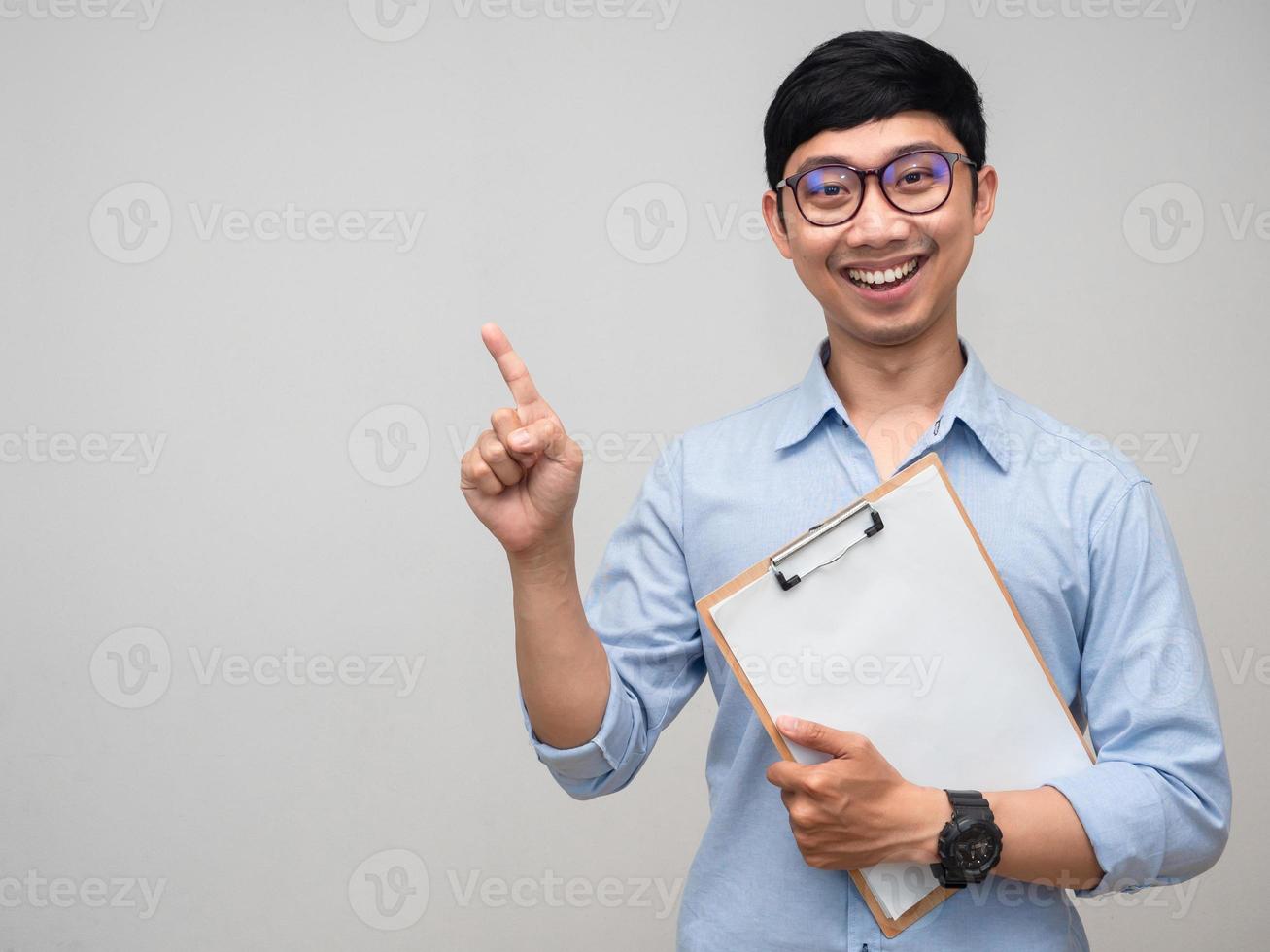 Positive man wear glasses with wood board document smile and gesture point finger photo