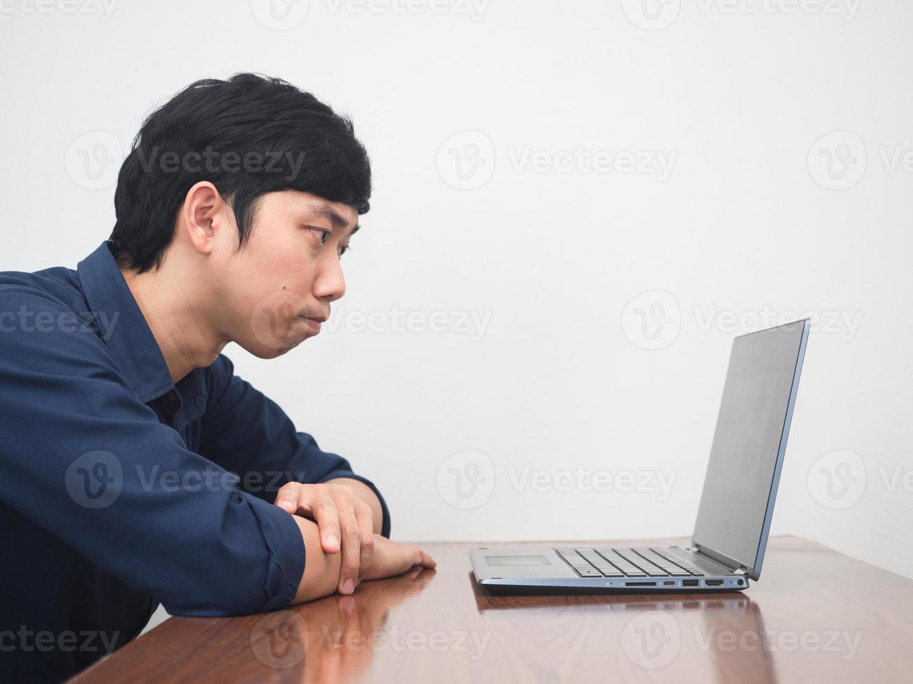 Male employee man feels tried with working at workplace table photo