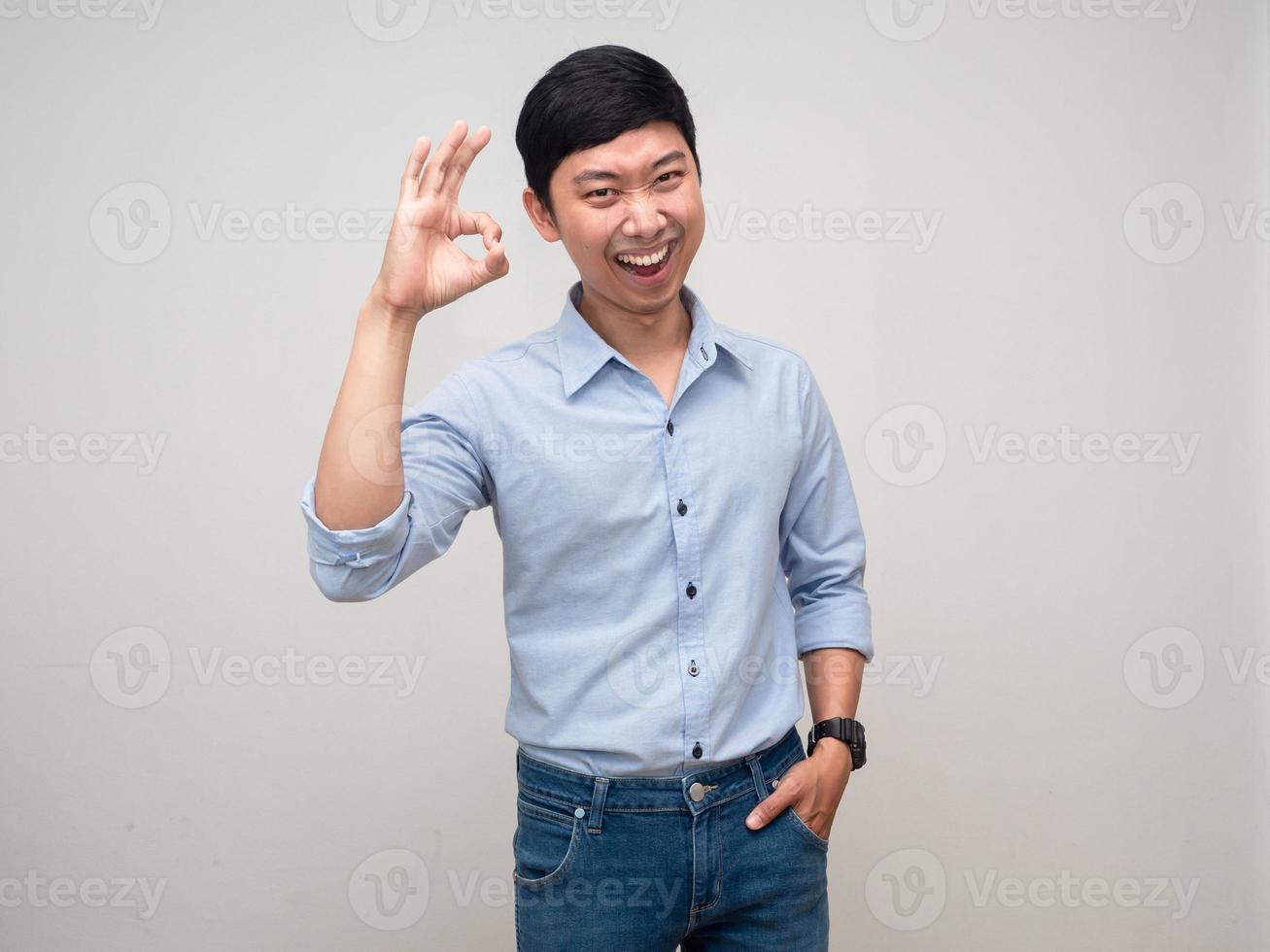 Cheerful man blue shirt happy emotion make hand ok isolated photo