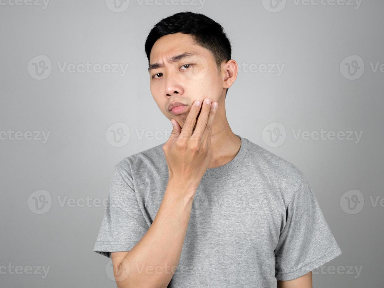 Asian man checking skin his face feels worried isolated photo