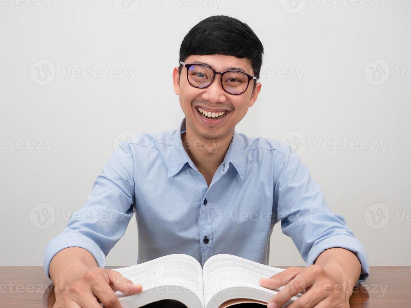 Cheerful asian businessman sit at working table smile at camera photo