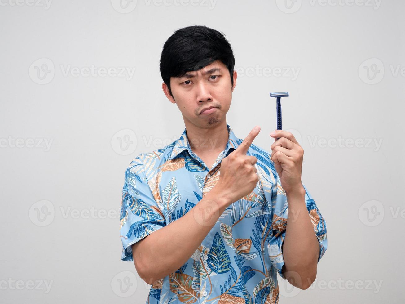 Asian man beach shirt point finger at shaving in hand feels doubt isolated photo