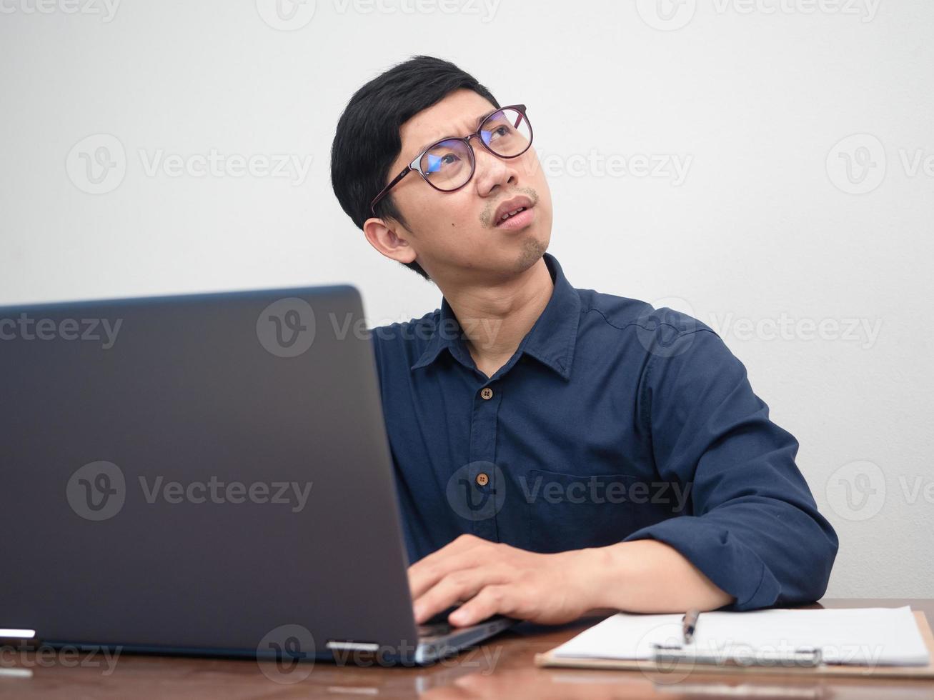 Asian businessman using laptop feels strain with working photo