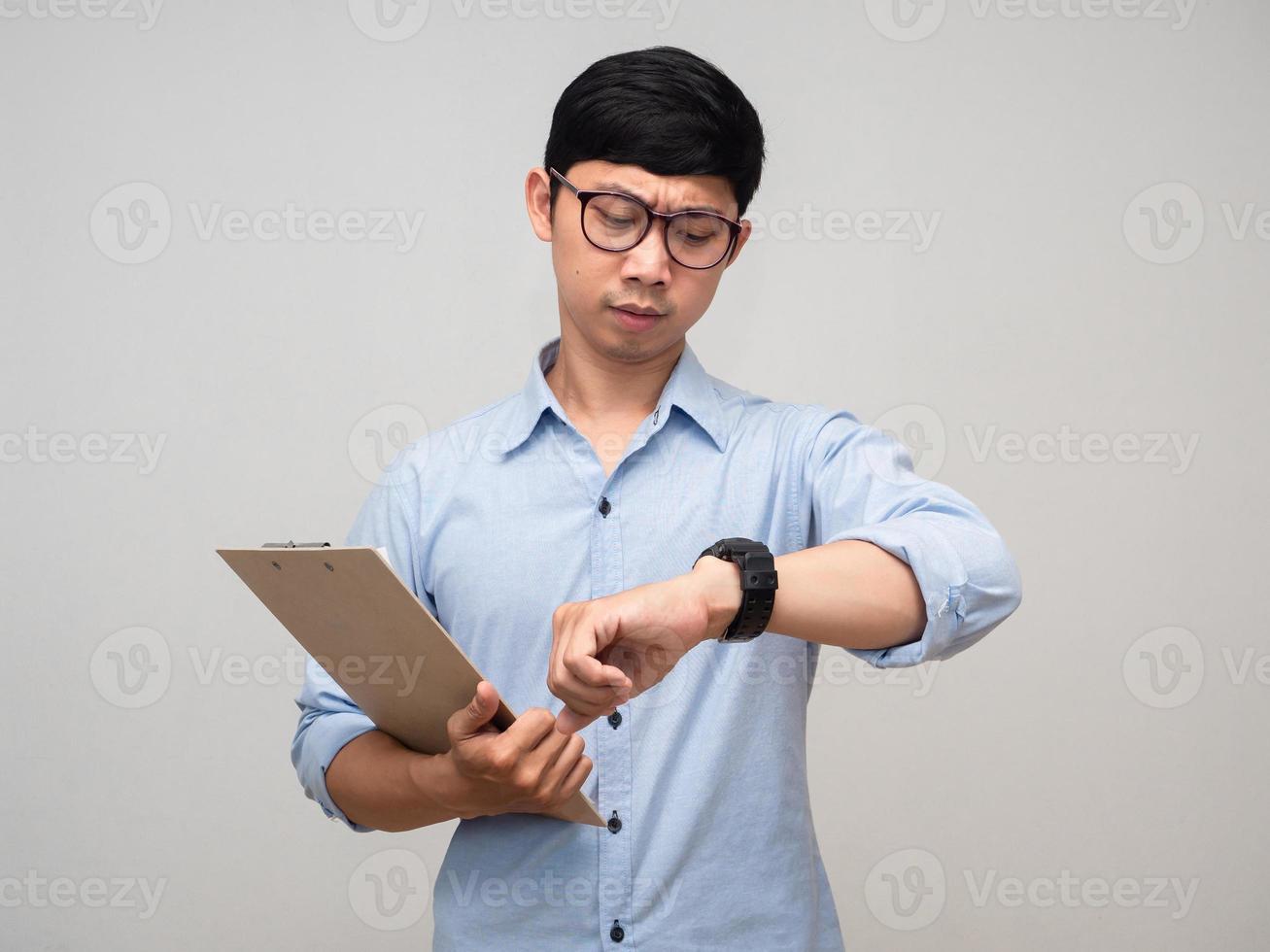 Businessman busy hold document board and looking at his watch isolated photo
