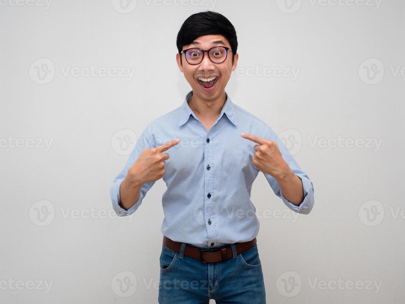 Male employee wear glasses blue shirt point finger at himself about choose me isolated photo