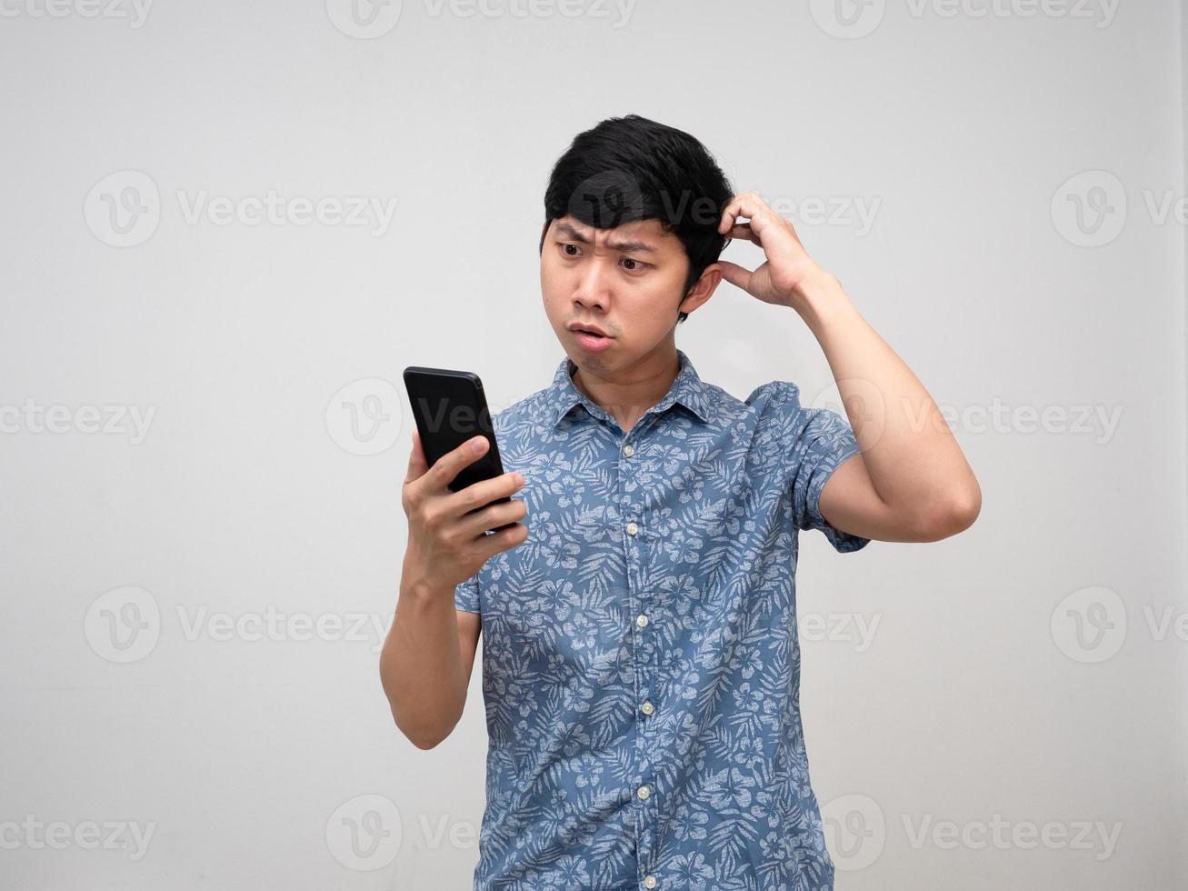 Confused asian man holding smartphone isolated photo