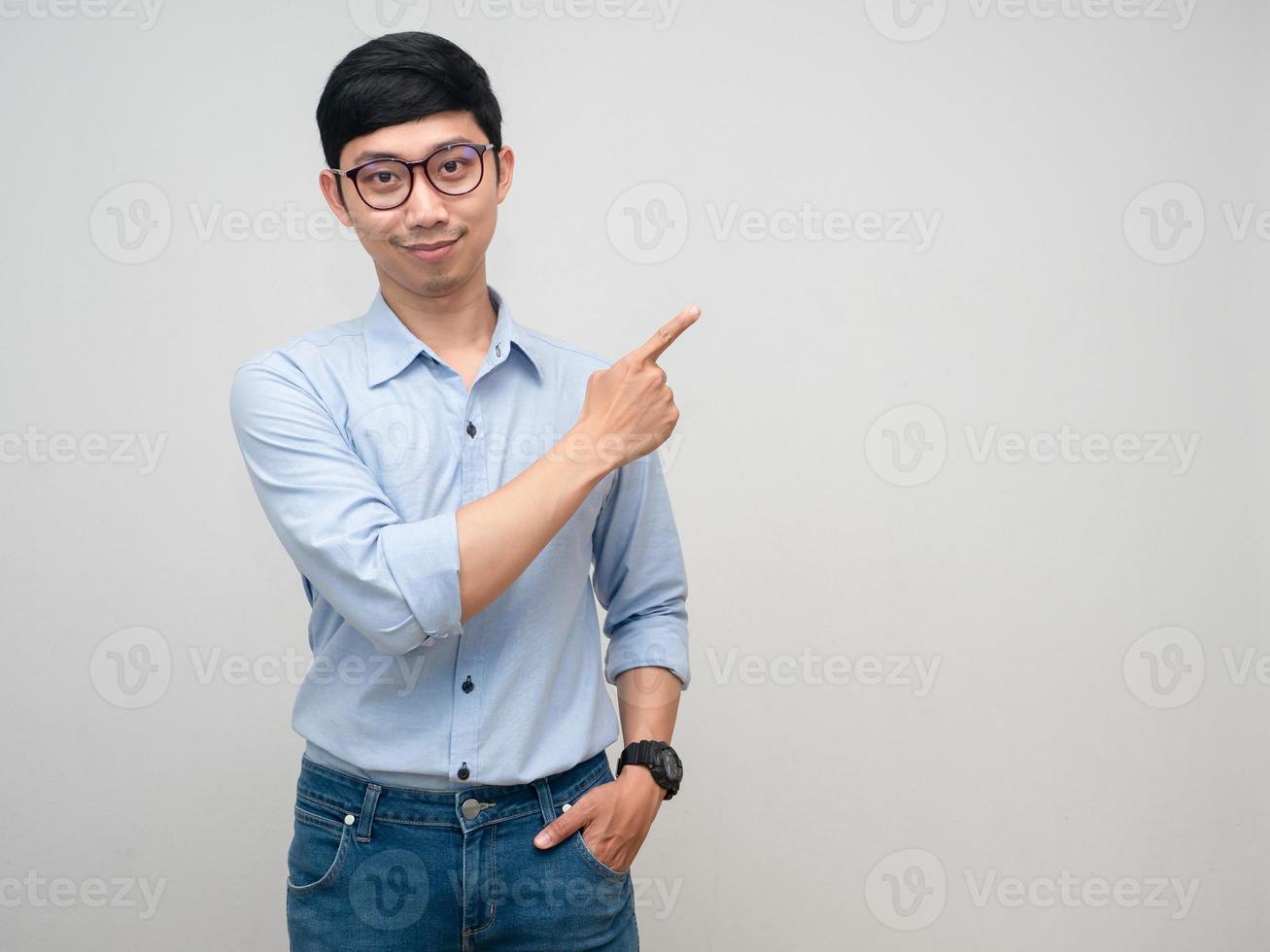 Asian businessman wear glasses gentle smile gesture point finger isolated photo