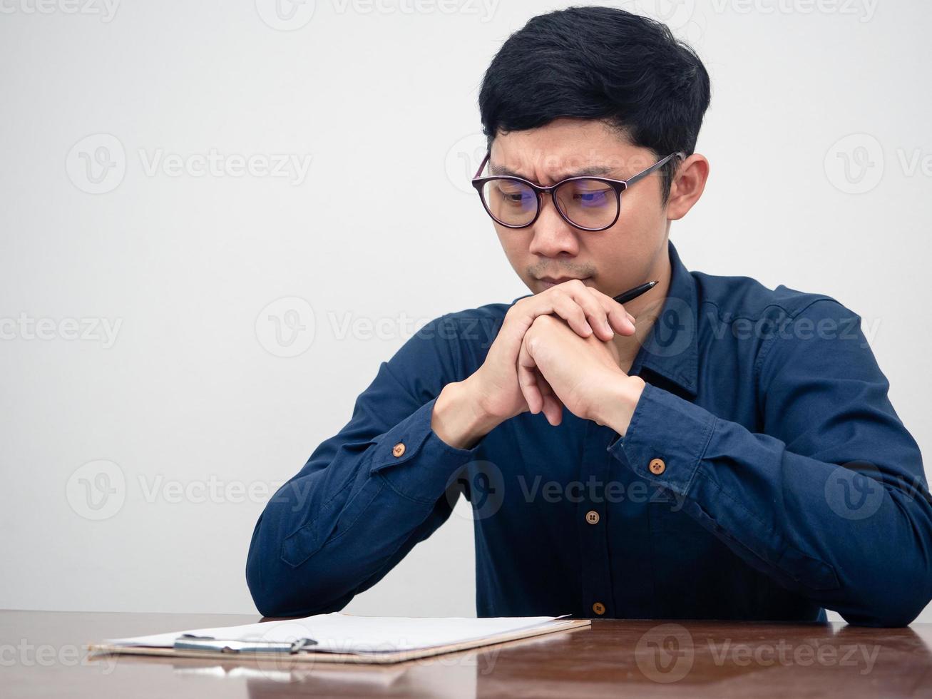 Young man wear glasses serious about testing on table photo