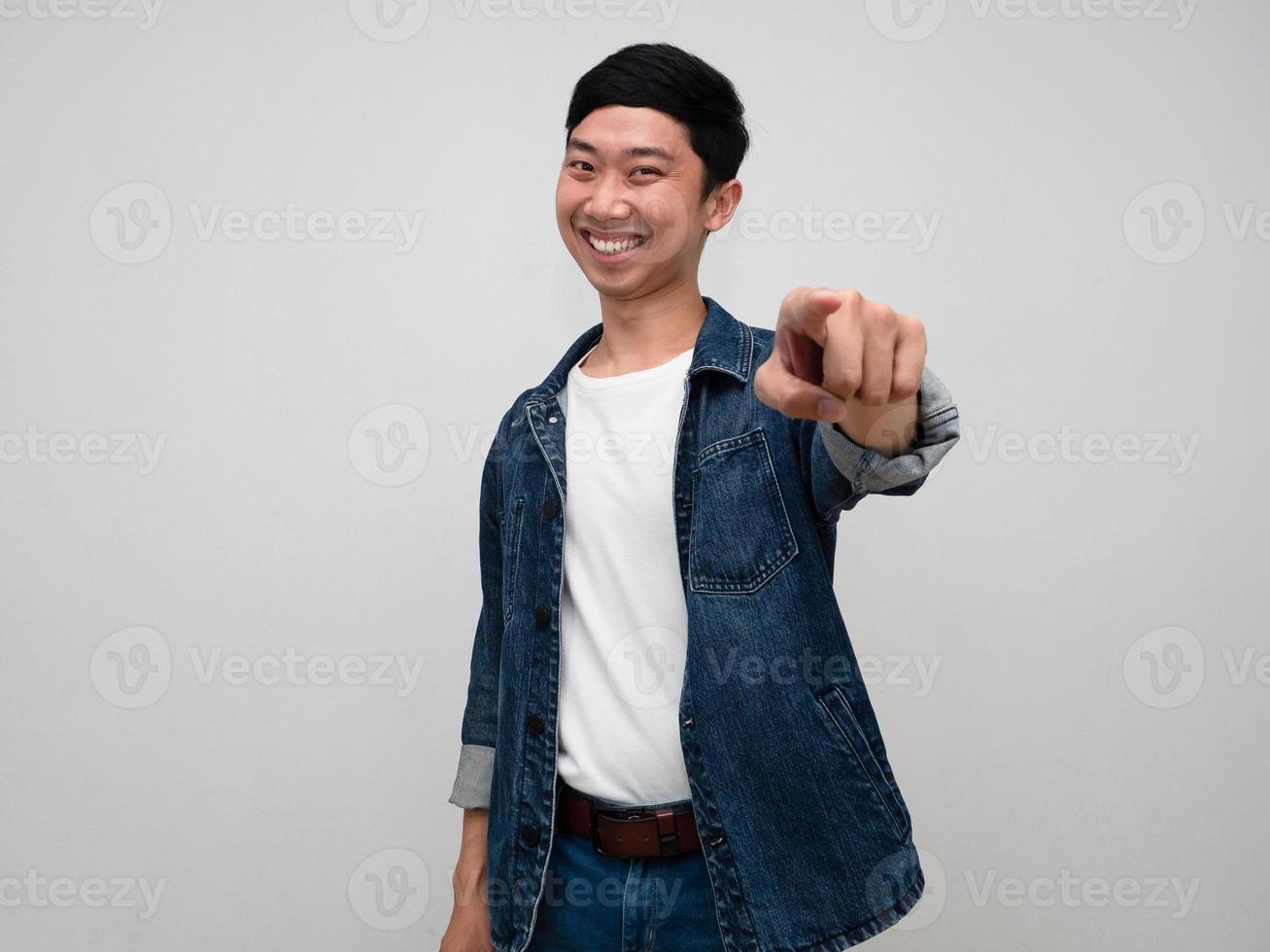 Cheerful asian man jeans shirt gesture point finger for choosing you isolated photo