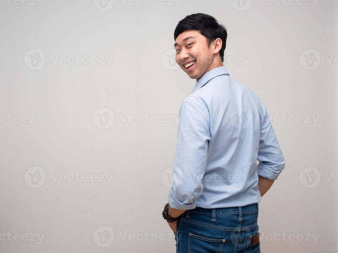 Positive man blue shirt happy smile turn back to looking at camera photo