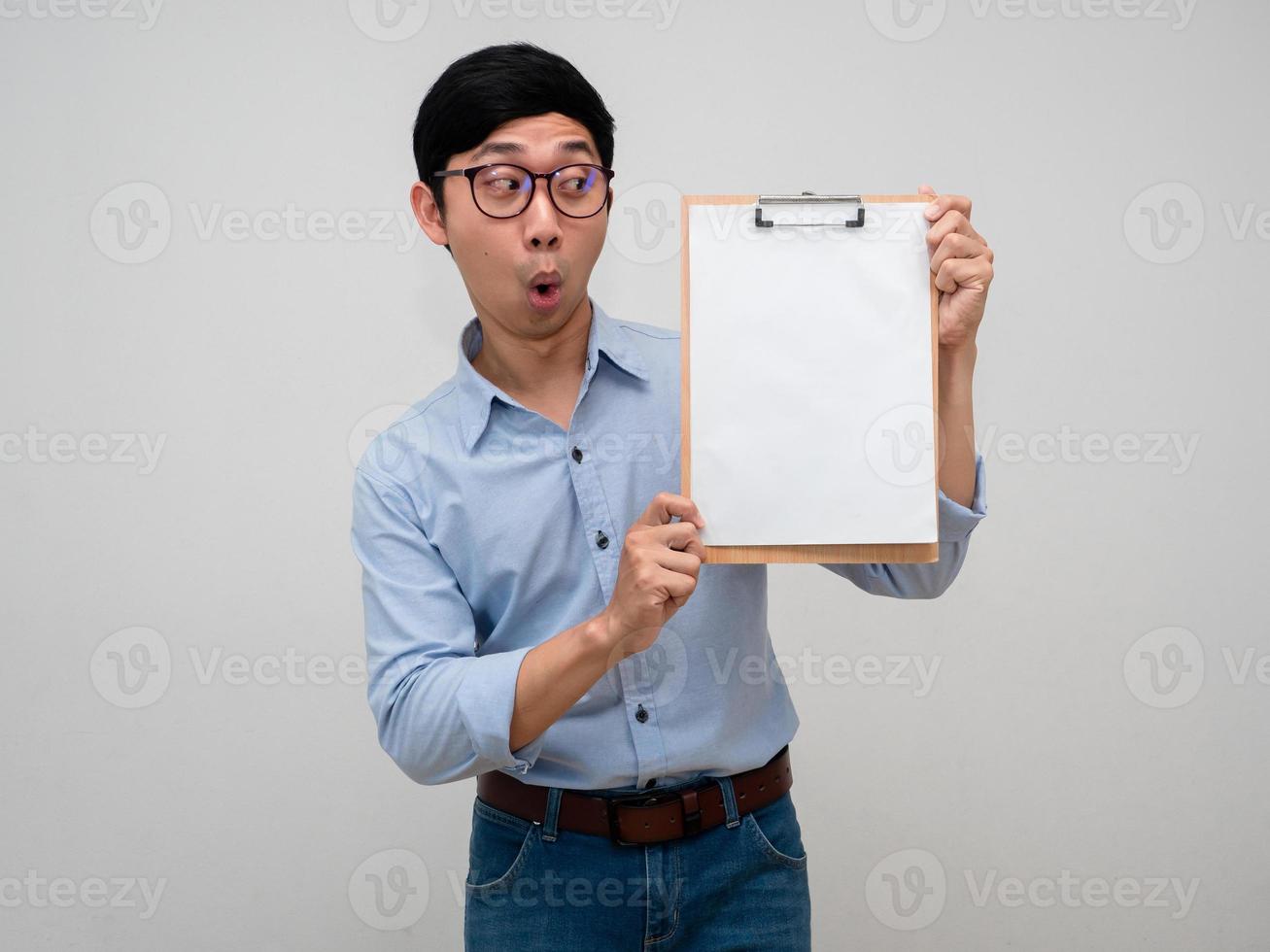 Positive businessman wear glasses feels amazed looking at document board in his hand isolated photo