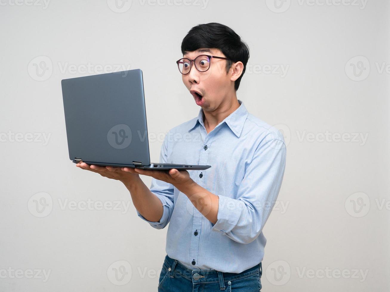 Young asian businessman feels amazed looking at laptop isolated photo