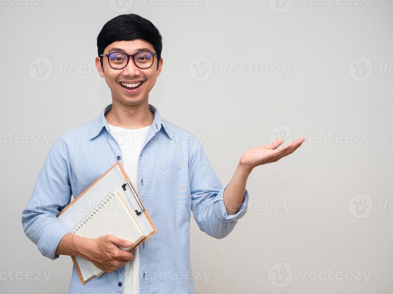 Cheerful teacher man hold diary and show hand up isolated photo