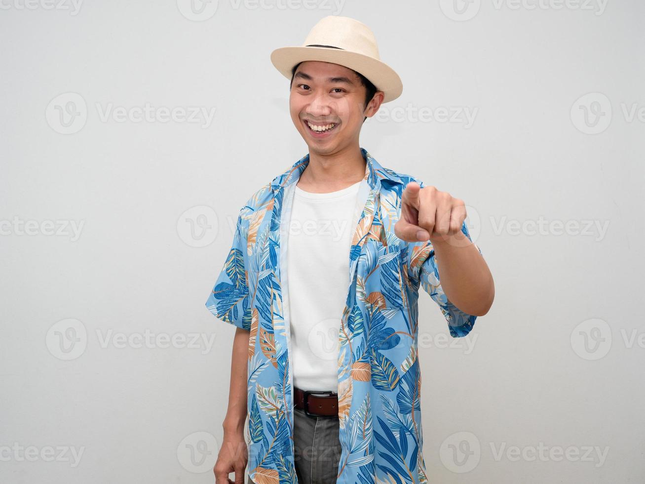 Positive tourism asian man beach shirt gentle smile gesture point finger at you isolated photo