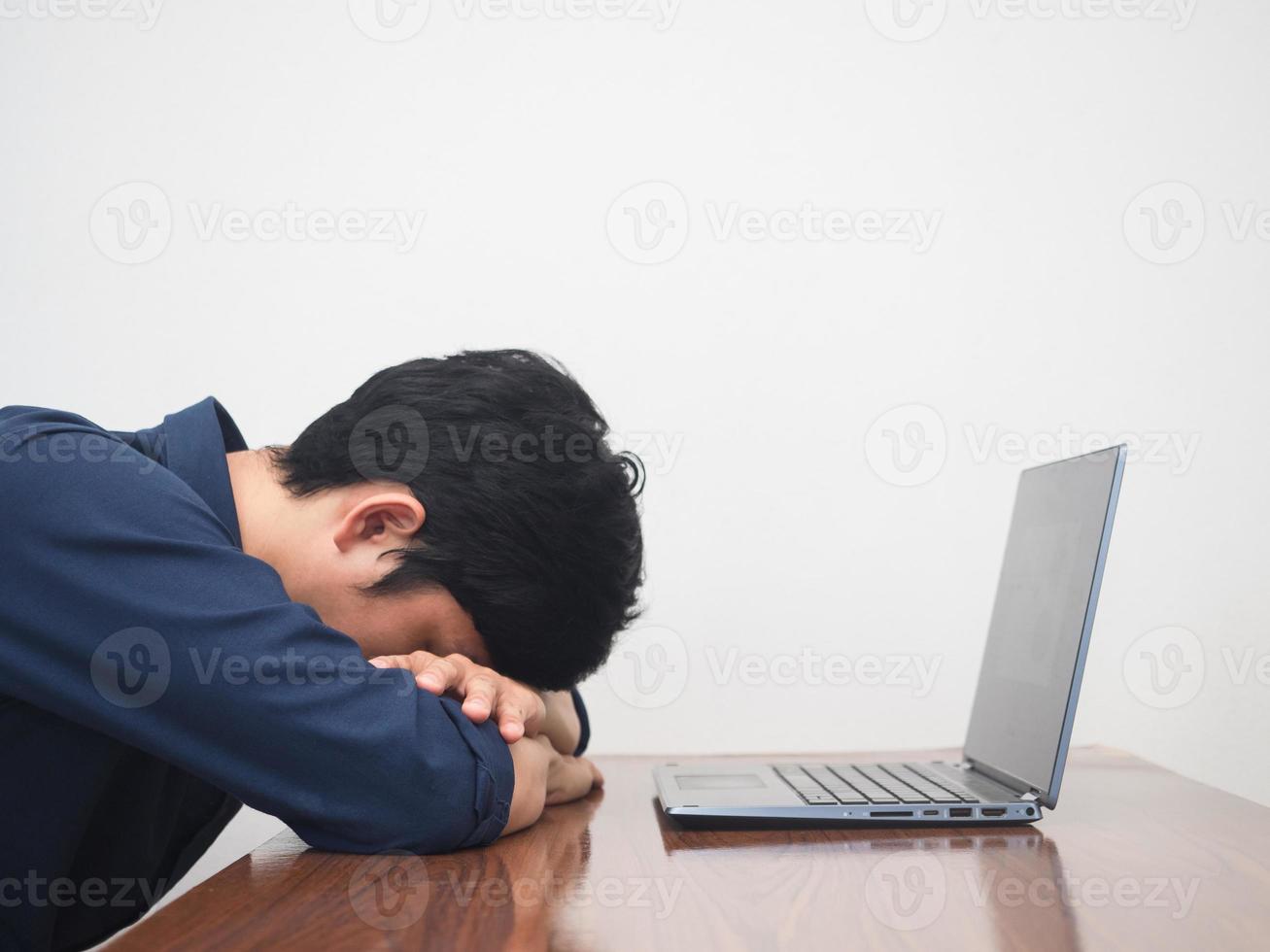 Male employee man feels tried with working at workplace table photo