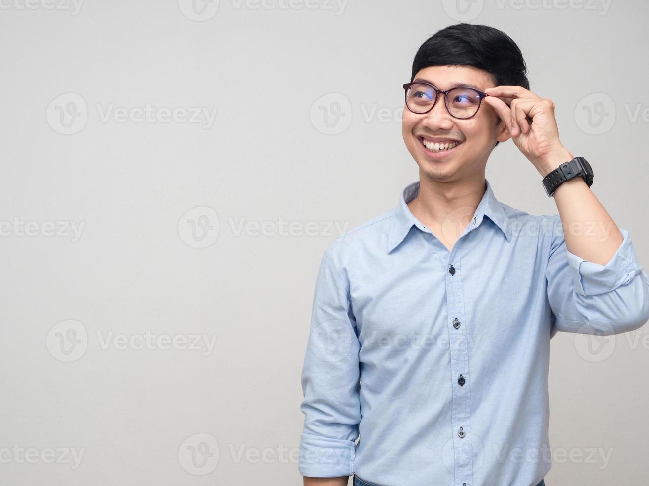 Cheerful businessman hold his glasses smile and looking at copy space photo