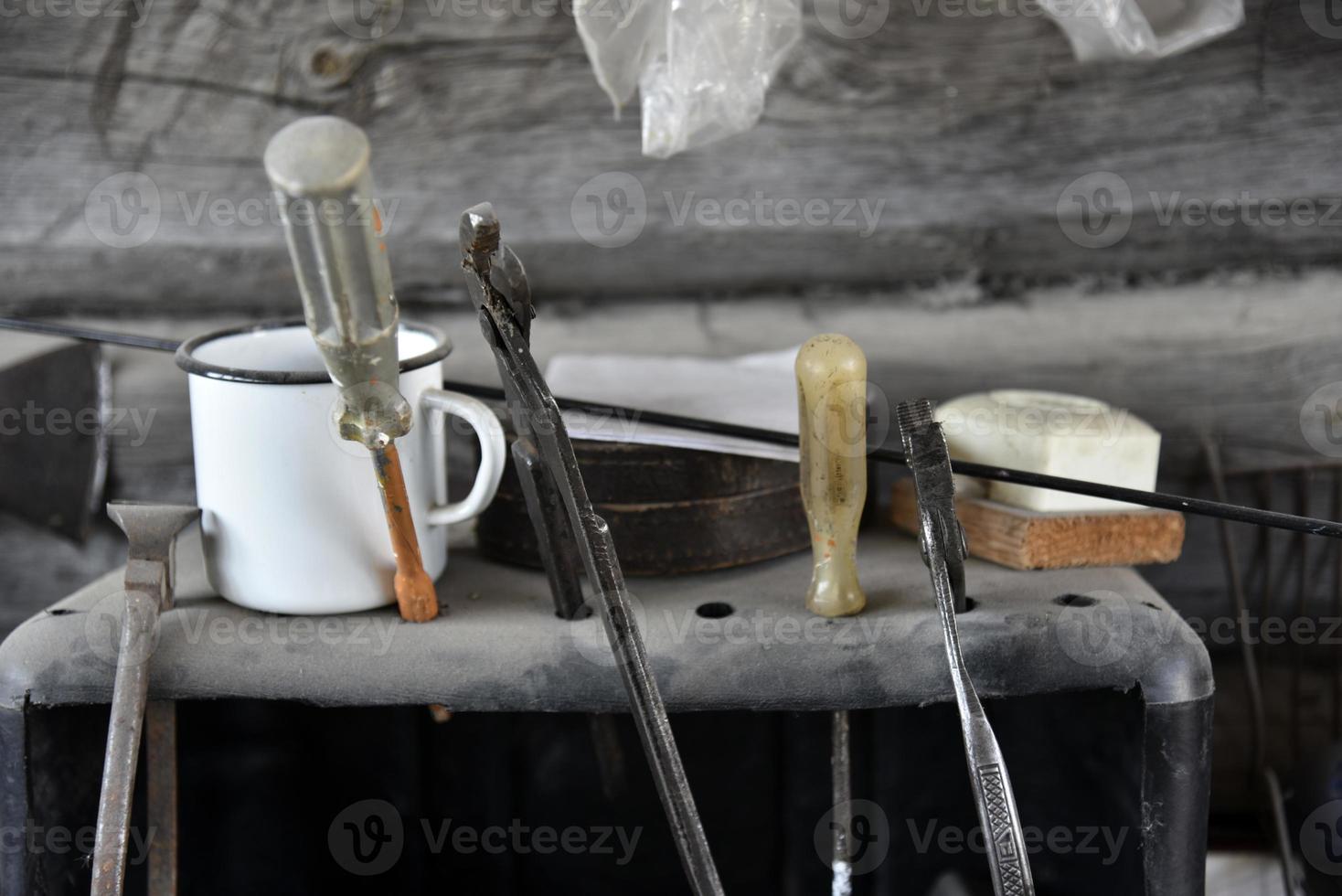 Old tools in a dusty shed. Tools in the garage on the shelf. photo