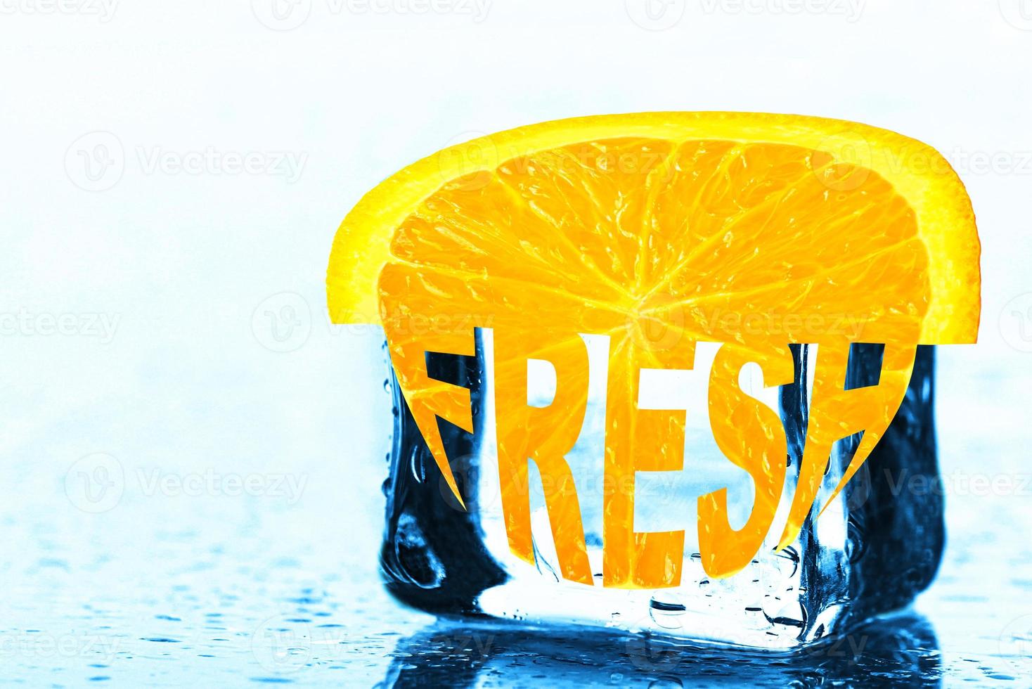 Fresh, creative text on an orange slice lying on an ice cube. photo