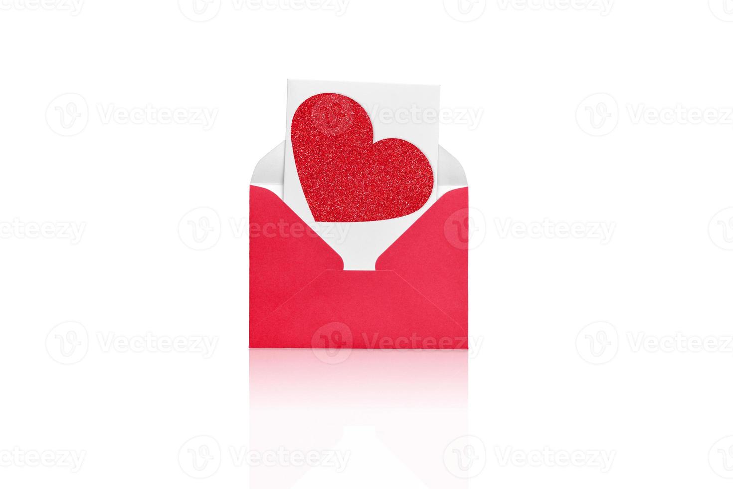 Red open envelope with a white sheet and red hear on a white background. photo