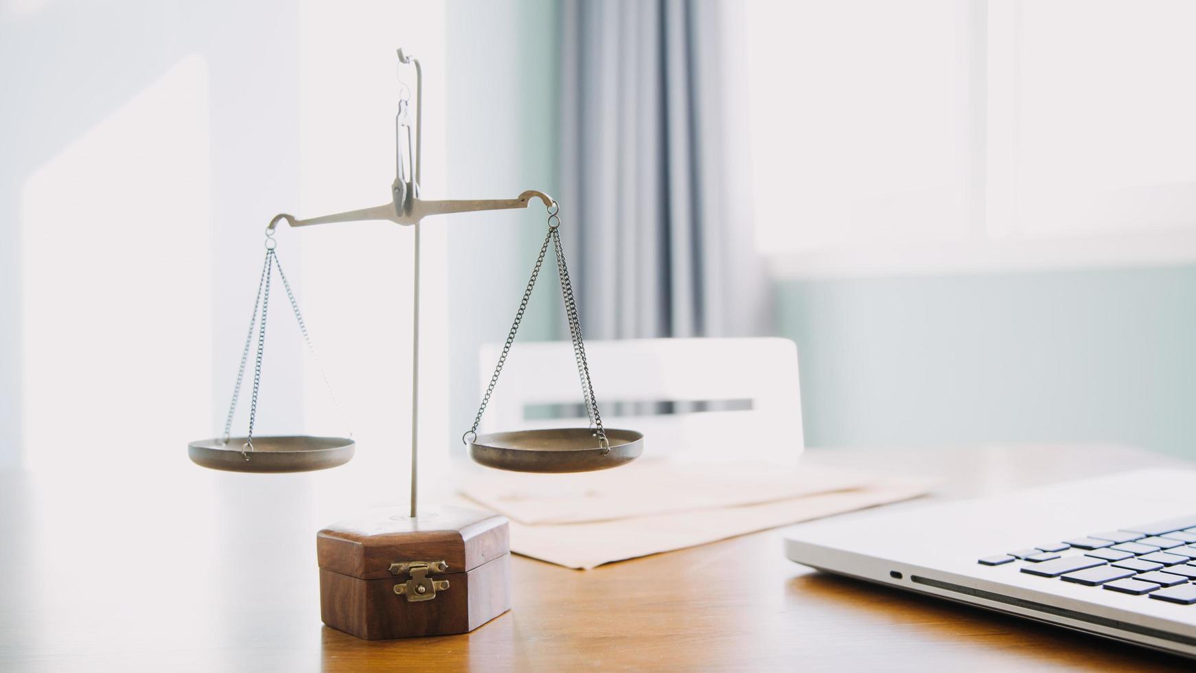 Business and lawyers discussing contract papers with brass scale on desk in office. Law, legal services, advice, justice and law concept picture with film grain effect photo