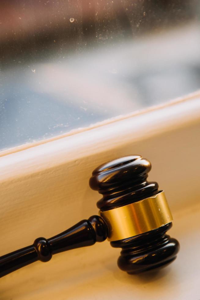 Business and lawyers discussing contract papers with brass scale on desk in office. Law, legal services, advice, justice and law concept picture with film grain effect photo
