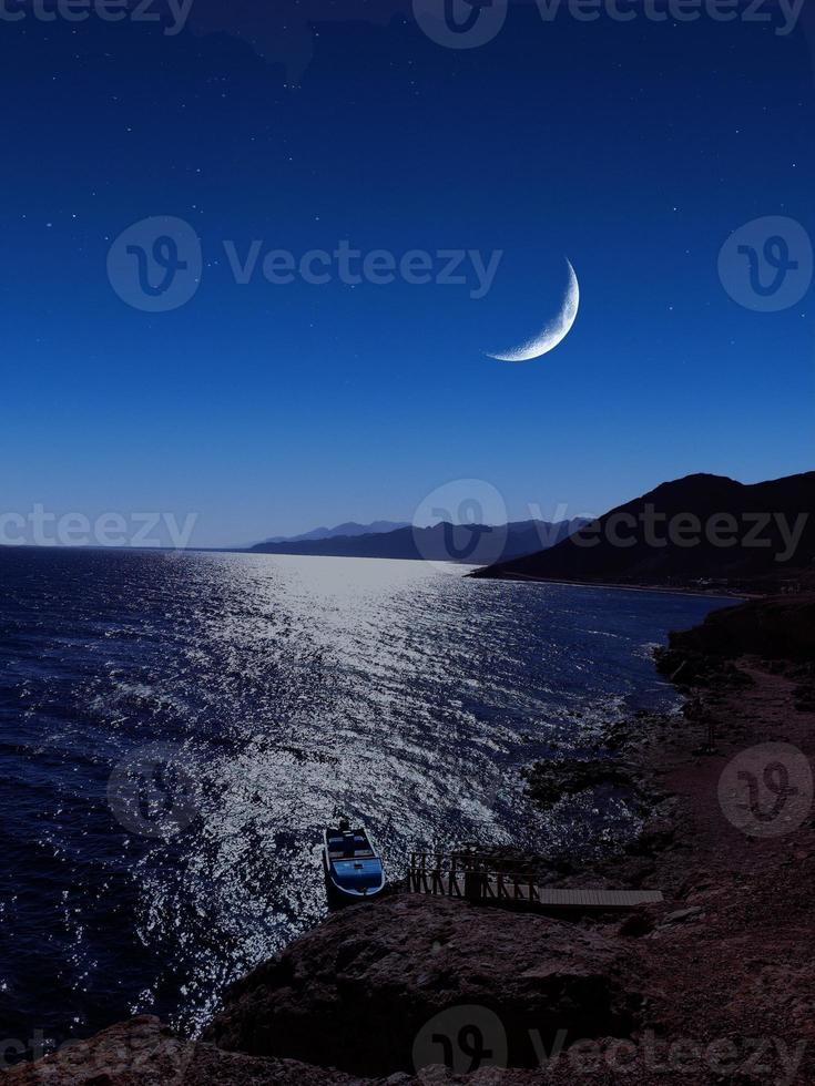 Scenic view of red sea at night with full moon above the sea and mountains photo