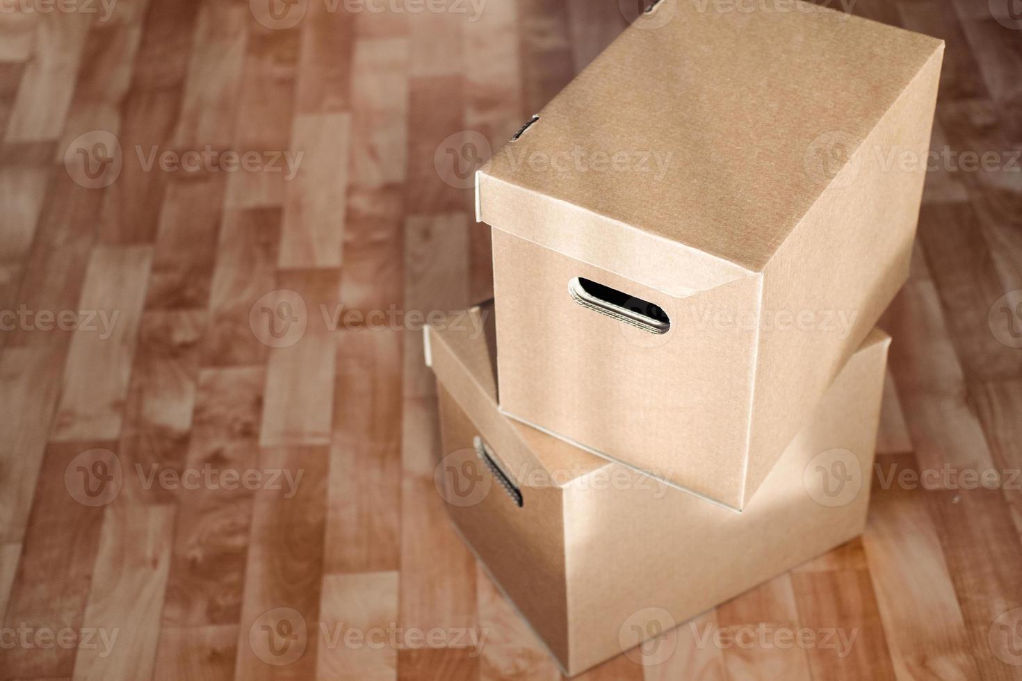 boxes on top of each other close-up on the floor. Moving theme with cardboard boxes photo
