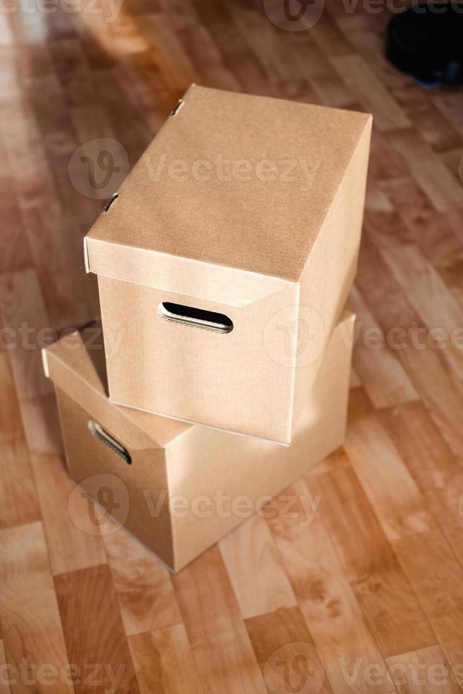 boxes on top of each other close-up on the floor. Moving theme with cardboard boxes photo