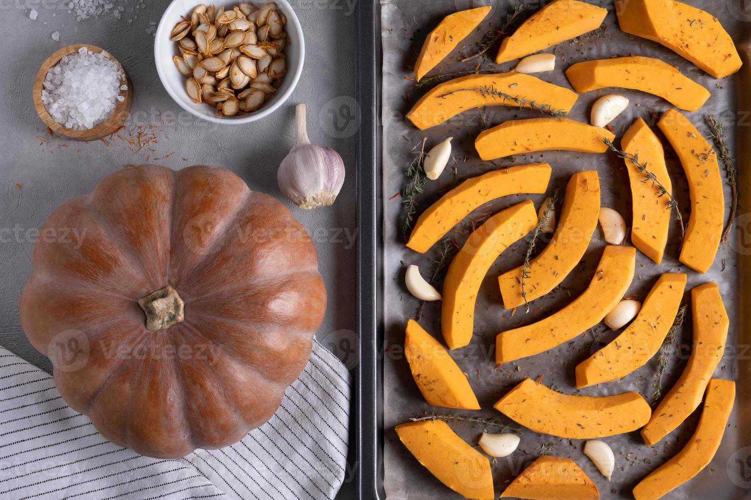 Ripe musk gourd and sliced gourd pieces on a baking sheet photo