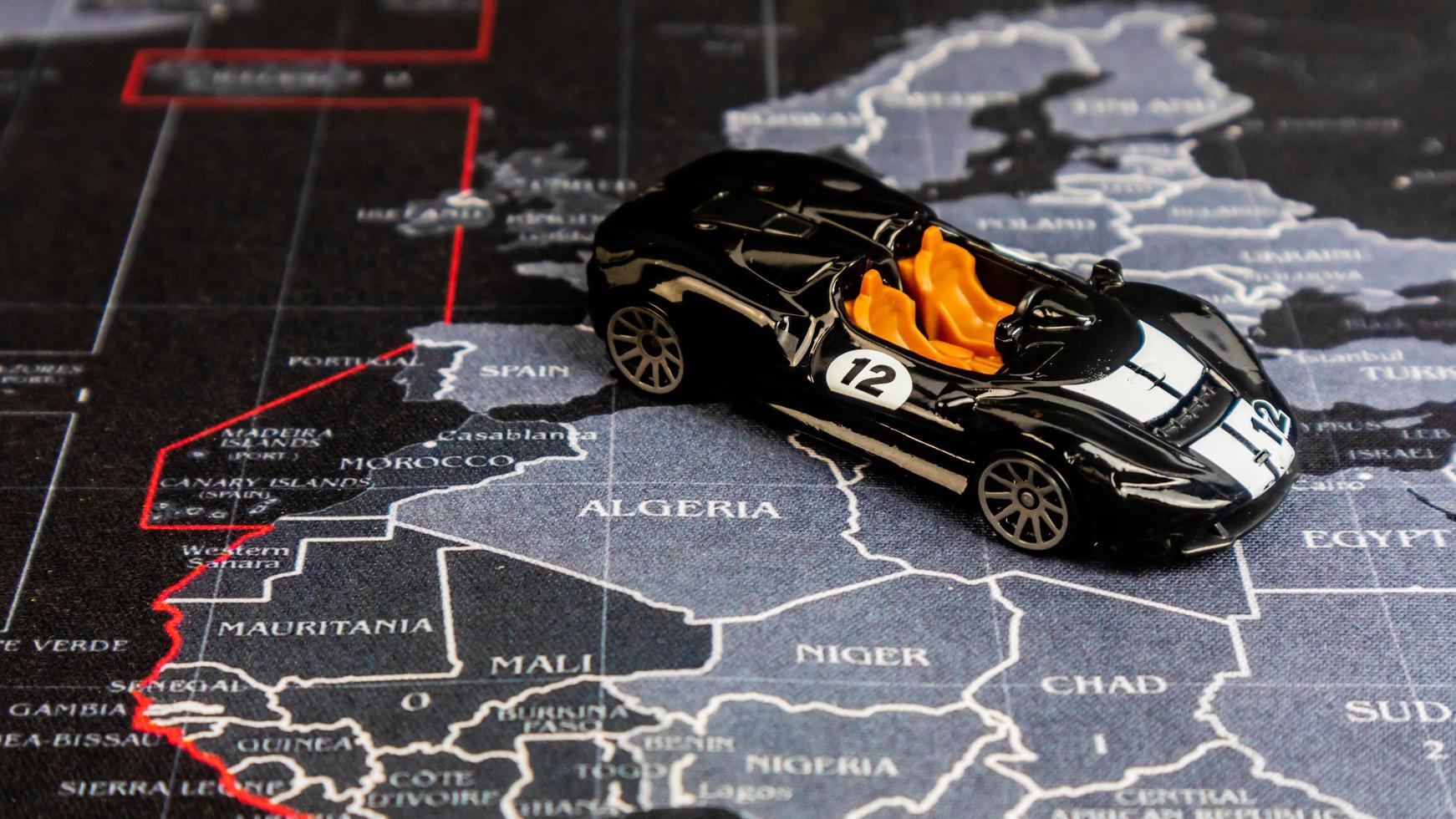 Minahasa, Indonesia  December 2022, toy car is black over the map photo