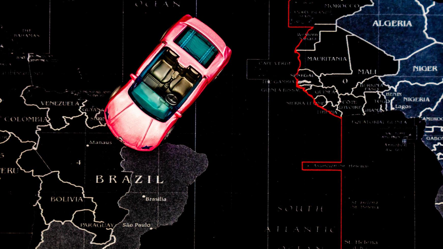 Minahasa, Indonesia  December 2022, pink toy car over map photo