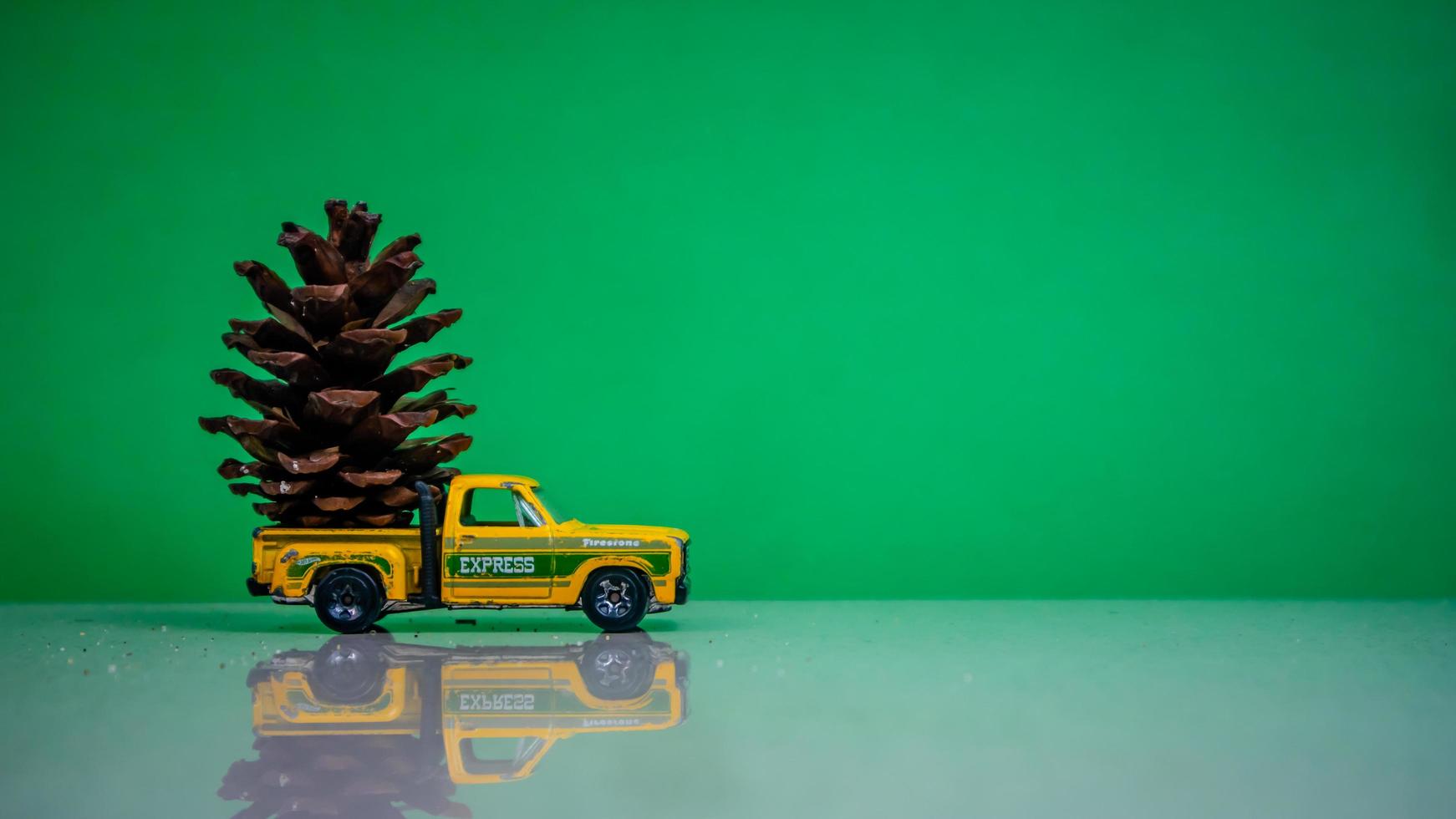 Minahasa, Indonesia  December 2022, the toy car transporting pinecones photo