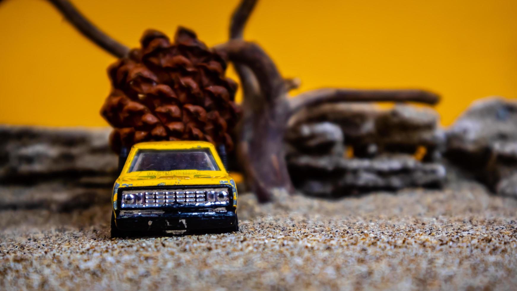 toy car hauling pinecones on an orange background photo