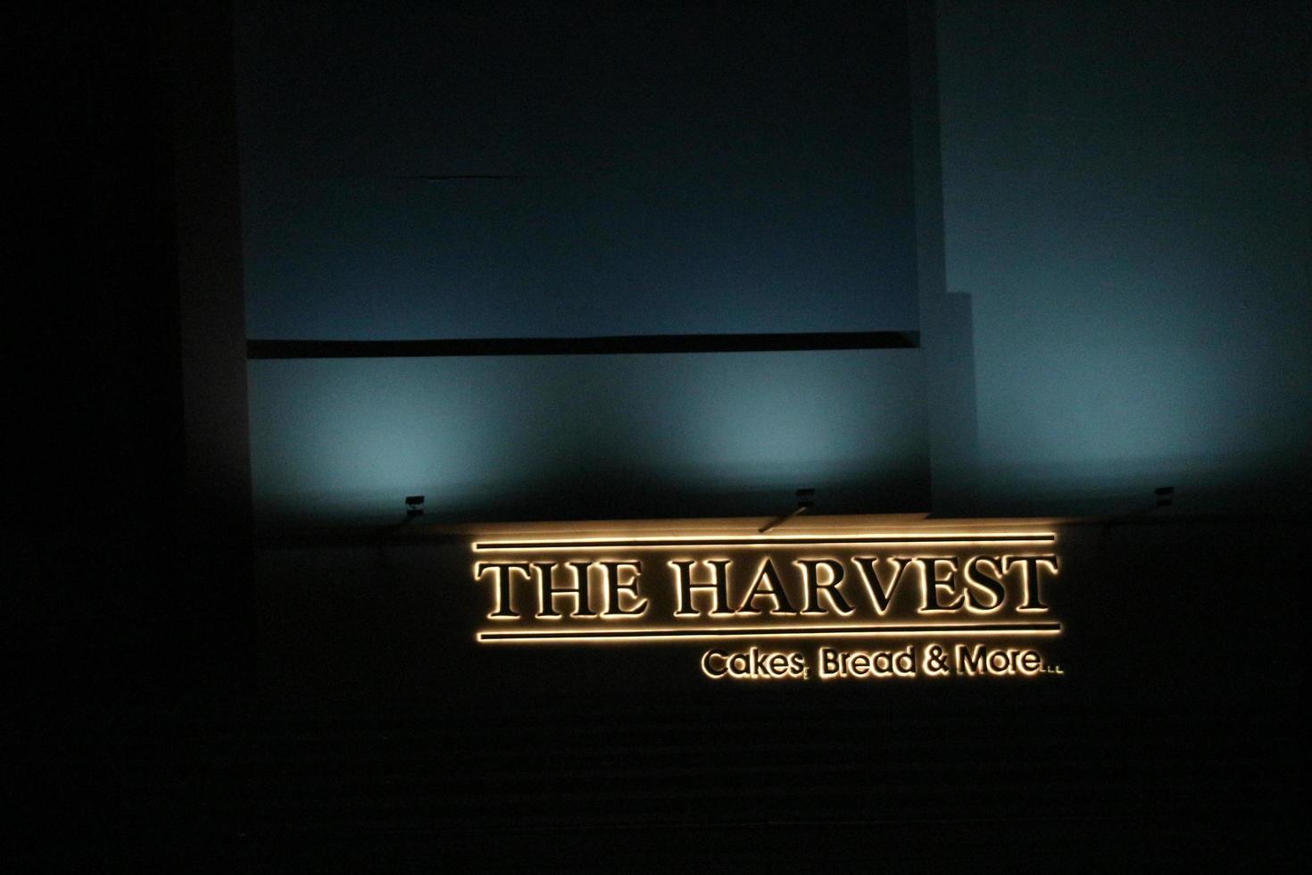 Bekasi, Indonesia in July 2022. The Harvest logo that shines brightly at night against the dark night sky. photo