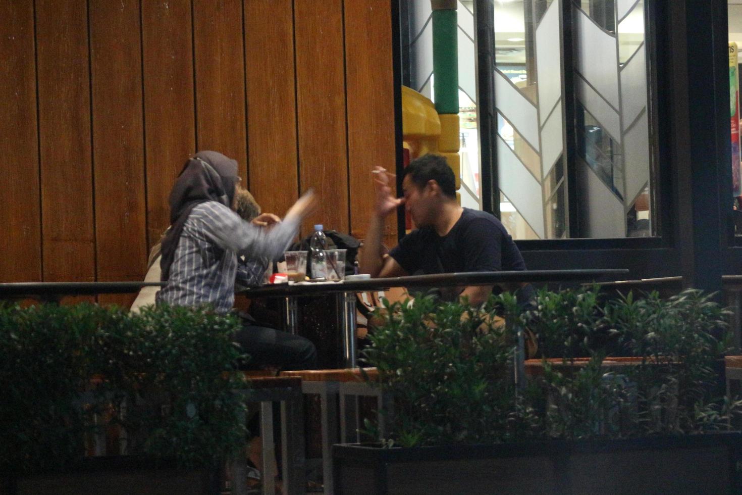 Bekasi, Indonesia in July 2022. A couple having dinner at a jusk food restaurant. photo