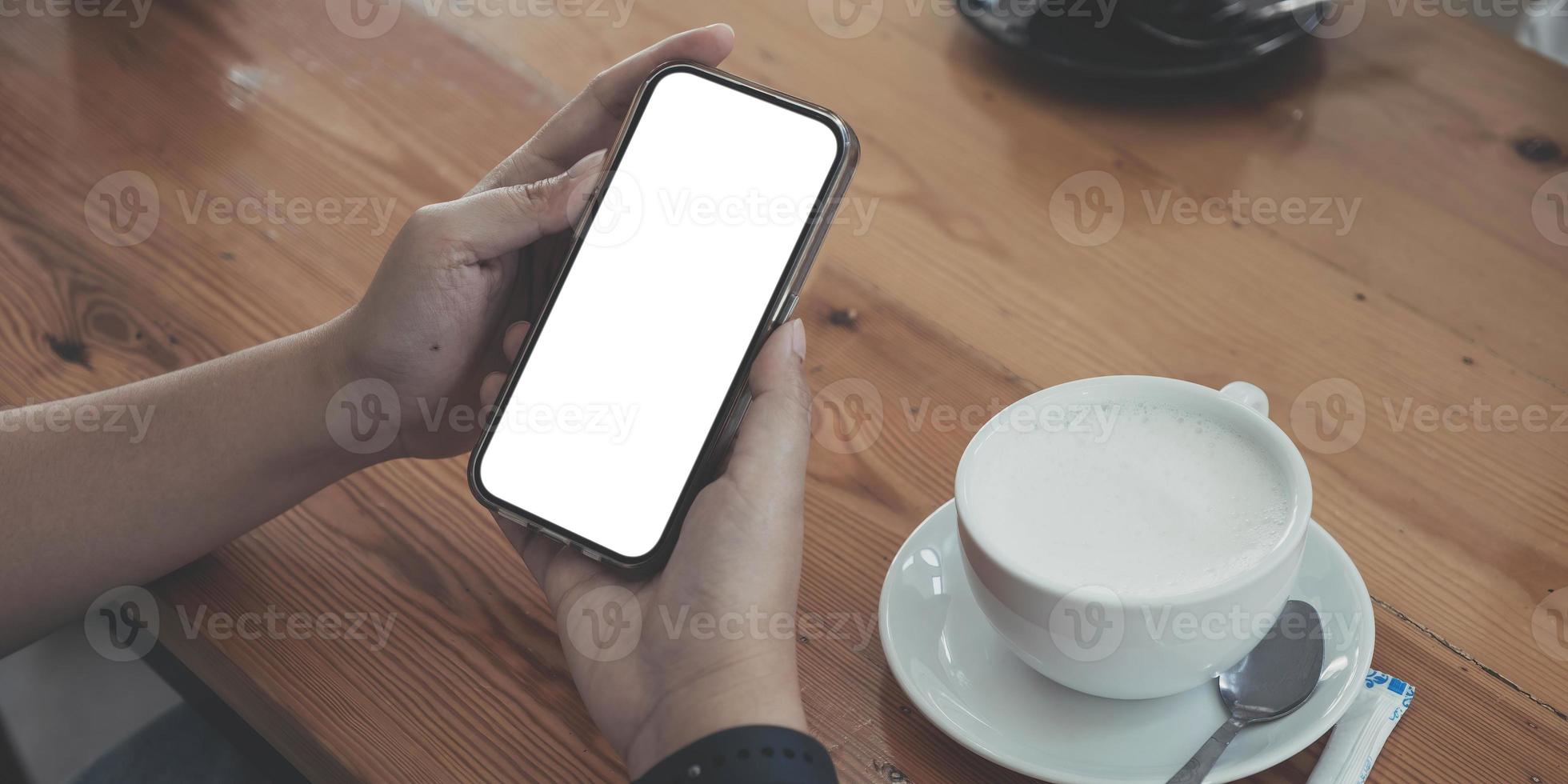 Close up of woman using cell phone,sending massages on the coffee shop.having sunbath.Phone with black screen,texting,video calls, photo