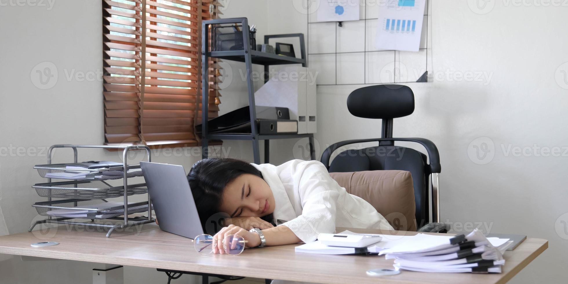 Tired female employee holding head on hand, looking at computer screen, doing hard task, having problem with computer software. Stressed exhausted businesswoman suffering from headache, feeling bored. photo