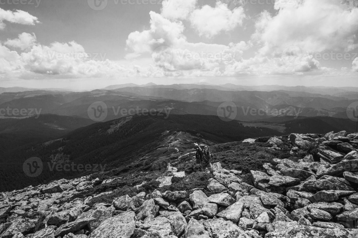Tourist on mountain ridge monochrome landscape photo