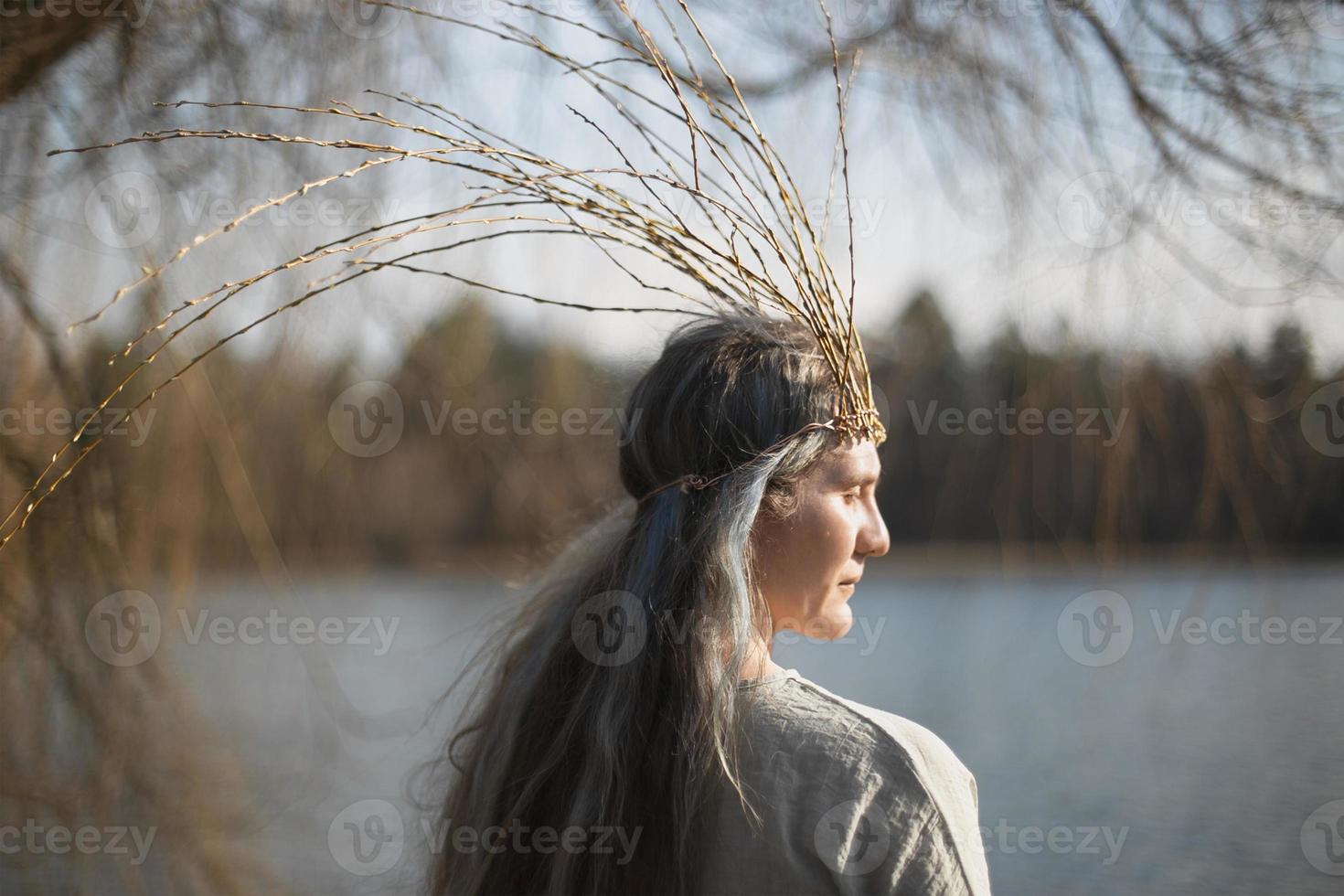 Close up middle age woman with willow branches crown portrait picture photo