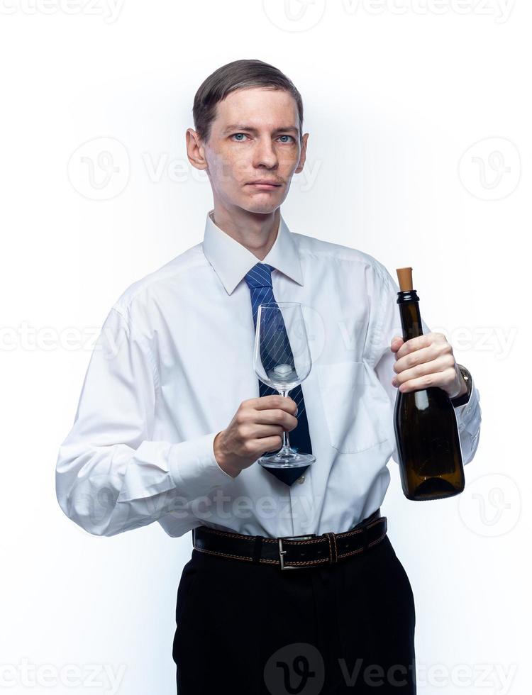 Business man with a glass and a bottle of wine in his hands on a white, isolated background photo