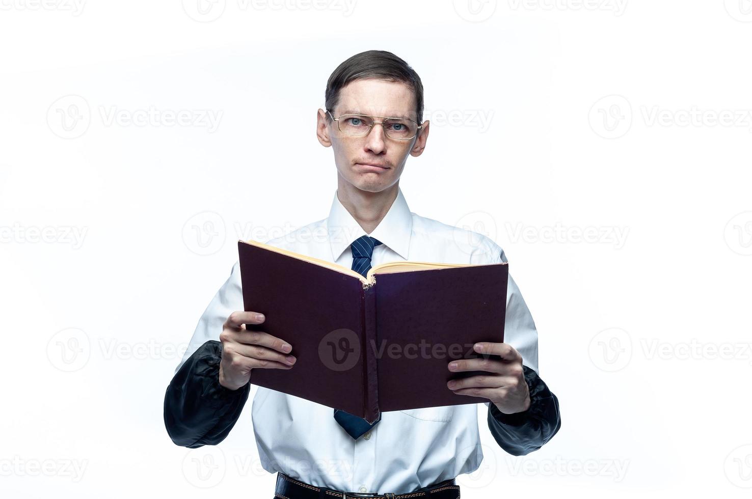 A business man in a tie and glasses with a magazine in his hands on a white, isolated background photo