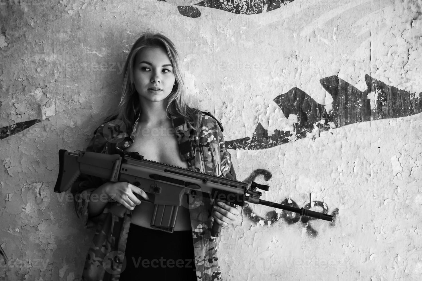 Beautiful portrait of a girl holding a gun photo