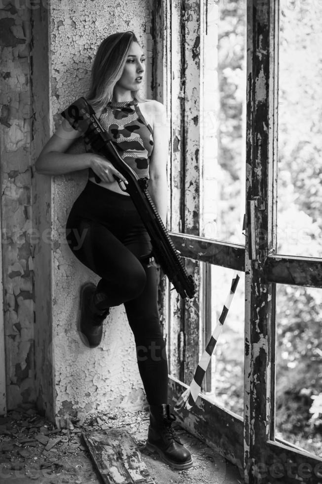 Beautiful portrait of a girl holding a gun photo