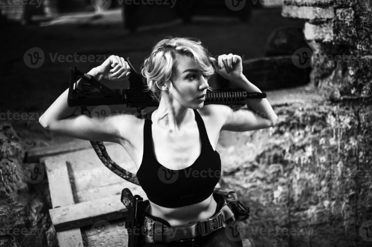 Beautiful portrait of a girl holding a gun photo