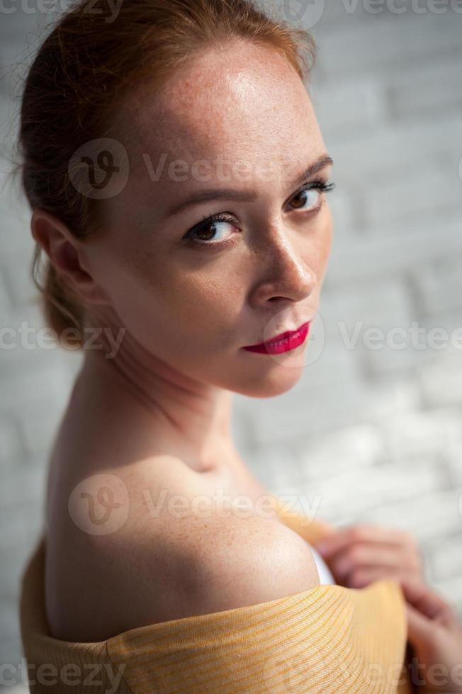 Girl posing against a white wall in her underwear photo