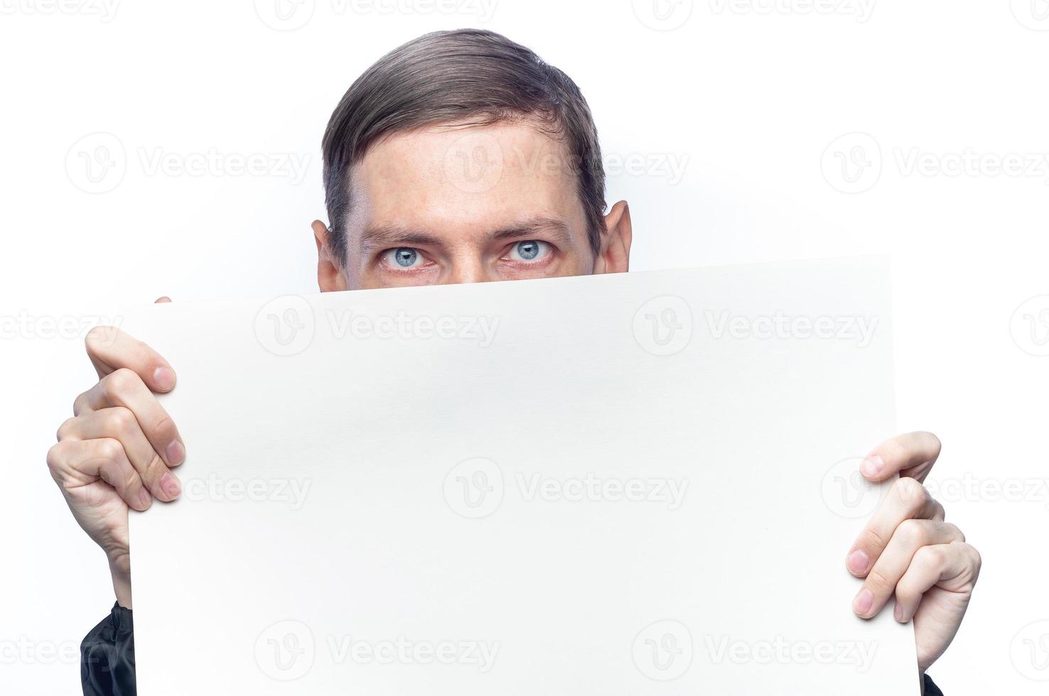 The person's face is covered with a white piece of paper, on an isolated background photo